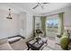 Comfortable living room featuring a ceiling fan, natural light from the window, and neutral-toned furniture at 3893 Wind Dancer Cir, St Cloud, FL 34772