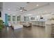 Open-concept living space with modern tile flooring, an island with seating, and a comfortable sectional sofa at 3893 Wind Dancer Cir, St Cloud, FL 34772