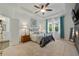 Serene main bedroom featuring tray ceilings, soft carpet, a comfortable bed, and ample natural light from the windows at 3893 Wind Dancer Cir, St Cloud, FL 34772