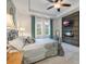 Main bedroom showcases decorative accent wall, fireplace, tv, tray ceiling, and ensuite bath access at 3893 Wind Dancer Cir, St Cloud, FL 34772