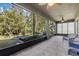 Enclosed patio with tiled floor and views of a garden, birdbath and banana trees at 3893 Wind Dancer Cir, St Cloud, FL 34772