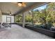 Enclosed patio featuring tile flooring and large windows providing views of the garden at 3893 Wind Dancer Cir, St Cloud, FL 34772