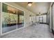 Enclosed patio with tile flooring, wicker furniture, and views of the lush backyard at 3893 Wind Dancer Cir, St Cloud, FL 34772