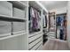 A well-organized walk-in closet featuring ample storage with shelving, drawers, and hanging space at 3893 Wind Dancer Cir, St Cloud, FL 34772