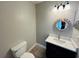 Half bath with modern vanity and decorative mirror at 3922 Crayrich Cir # C-4, Orlando, FL 32839