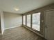 Spacious living area with three large windows providing natural light and new flooring at 3922 Crayrich Cir # C-4, Orlando, FL 32839