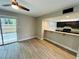Living area featuring wood-look floors, access to the backyard and a breakfast bar to the kitchen at 3922 Crayrich Cir # C-4, Orlando, FL 32839