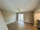 Bright living room with wood floors, ceiling fan and sliding doors leading to the outside at 3922 Crayrich Cir # C-4, Orlando, FL 32839