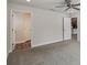 Bedroom featuring neutral walls, carpet, ceiling fan, and two doors leading to other rooms at 442 Big Black Pl, Kissimmee, FL 34759