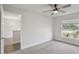 Neutral bedroom features a window and ceiling fan at 442 Big Black Pl, Kissimmee, FL 34759