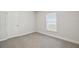 Neutral bedroom features a window and a door at 442 Big Black Pl, Kissimmee, FL 34759