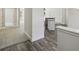 Hallway showcasing a transition from carpeted space to wood-look floors with neutral wall colors at 442 Big Black Pl, Kissimmee, FL 34759