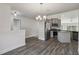 The kitchen has stainless steel appliances, a granite countertop island, and wood-look flooring at 442 Big Black Pl, Kissimmee, FL 34759