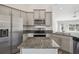 Kitchen with stainless steel appliances, granite countertops, gray cabinets, and hardwood-style flooring and island at 442 Big Black Pl, Kissimmee, FL 34759