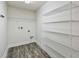 Laundry room featuring wood-look floors, shelving, and utility connections at 442 Big Black Pl, Kissimmee, FL 34759