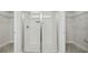 Walk-in shower with glass doors and white tile in a modern bathroom at 442 Big Black Pl, Kissimmee, FL 34759