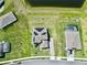 Aerial view of a home with solar panels, spacious lawn, and close proximity to a pond in a sunny neighborhood at 4512 Cutwater Dr, Orlando, FL 32820