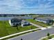 Stunning aerial view of a home with a serene lake backdrop and well-manicured lawn at 4512 Cutwater Dr, Orlando, FL 32820