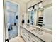 Bathroom with dual vanity sinks and white cabinets, leading to bedrooms and shower space at 4512 Cutwater Dr, Orlando, FL 32820