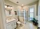 Bathroom featuring a glass shower, vanity, and views of the outdoors at 4512 Cutwater Dr, Orlando, FL 32820
