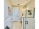 Hallway to the bathroom featuring a glass shower, vanity, and white wainscoting at 4512 Cutwater Dr, Orlando, FL 32820