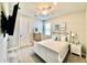 Comfortable bedroom with modern furniture, TV, and a decorative mirror at 4512 Cutwater Dr, Orlando, FL 32820