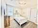 Inviting bedroom with plenty of light, dresser, and white bedding at 4512 Cutwater Dr, Orlando, FL 32820