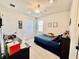 Bright bedroom featuring a ceiling fan, playful decor, and comfortable carpeting at 4512 Cutwater Dr, Orlando, FL 32820