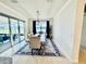 Bright dining room featuring modern lighting, neutral walls, stylish rug, and sliding glass door to outdoor space at 4512 Cutwater Dr, Orlando, FL 32820
