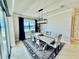 Dining room features modern chandelier, accent rug, natural light and patio access with beautiful lake view at 4512 Cutwater Dr, Orlando, FL 32820