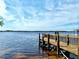 Beautiful wooden dock extending into a tranquil lake, perfect for relaxation and enjoying the waterfront at 4512 Cutwater Dr, Orlando, FL 32820