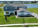 Beautiful two-story home featuring manicured lawn and picturesque water view, perfect for serene living at 4512 Cutwater Dr, Orlando, FL 32820