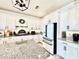 This bright kitchen features white cabinets, granite counters and stainless appliances at 4512 Cutwater Dr, Orlando, FL 32820