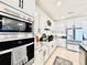 This kitchen features stainless appliances, granite counters, and lots of white cabinets and storage at 4512 Cutwater Dr, Orlando, FL 32820