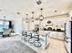 Stylish kitchen features granite counters, stainless appliances, an island with seating and pendant lights at 4512 Cutwater Dr, Orlando, FL 32820