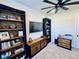 Office with book shelves, tv, and carpet at 4512 Cutwater Dr, Orlando, FL 32820