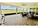 Covered patio with brick floors offering serene views of the pond at 4512 Cutwater Dr, Orlando, FL 32820