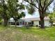 Backyard featuring a patio and well maintained lawn at 4638 River Ridge Dr, Leesburg, FL 34748