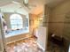 Bright bathroom featuring a tub under a large window and a walk-in shower at 4638 River Ridge Dr, Leesburg, FL 34748