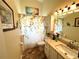 Bathroom with a floral shower curtain, and a vanity with a marble countertop at 4638 River Ridge Dr, Leesburg, FL 34748