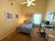 Cozy bedroom featuring blue decor and a dedicated workspace area at 4638 River Ridge Dr, Leesburg, FL 34748