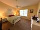 Bedroom featuring neutral decor, large window and dresser at 4638 River Ridge Dr, Leesburg, FL 34748