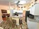 Well-appointed kitchen with breakfast bar, stainless appliances, and tile floors at 4638 River Ridge Dr, Leesburg, FL 34748