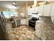 Updated kitchen boasts modern appliances, granite countertops, and tile flooring at 4638 River Ridge Dr, Leesburg, FL 34748