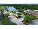 An aerial view of community featuring a lake, a fountain, a pool, and clubhouse at 4730 Capital Blvd, St Cloud, FL 34769