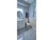Modern bathroom featuring stone tile, white cabinets and fixtures at 4730 Capital Blvd, St Cloud, FL 34769