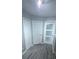 Hallway area featuring multiple doors and wood-look floors at 4730 Capital Blvd, St Cloud, FL 34769