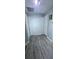 Hallway with laminate flooring and multiple doors at 4730 Capital Blvd, St Cloud, FL 34769