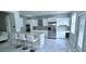 Modern kitchen with stainless steel appliances, granite countertops, tile backsplash, and breakfast bar at 4730 Capital Blvd, St Cloud, FL 34769