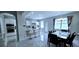 Open concept kitchen with stainless steel appliances, an island, and dining space with natural light at 4730 Capital Blvd, St Cloud, FL 34769